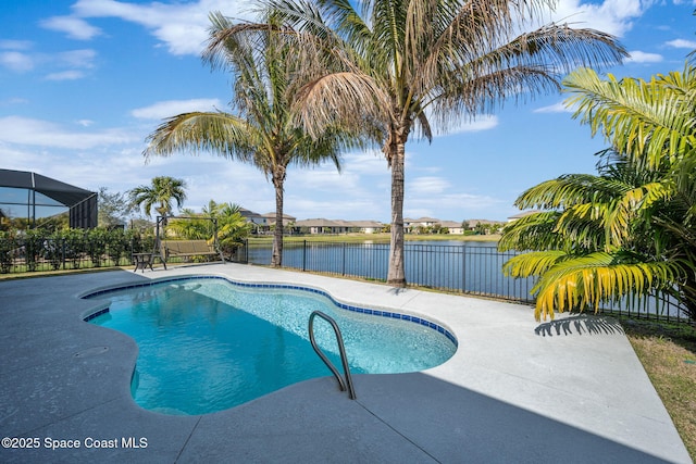 view of swimming pool with a patio and a water view