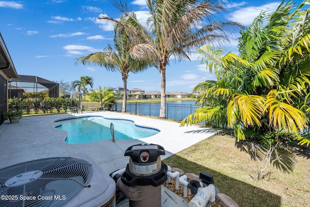 view of pool with a patio and a water view