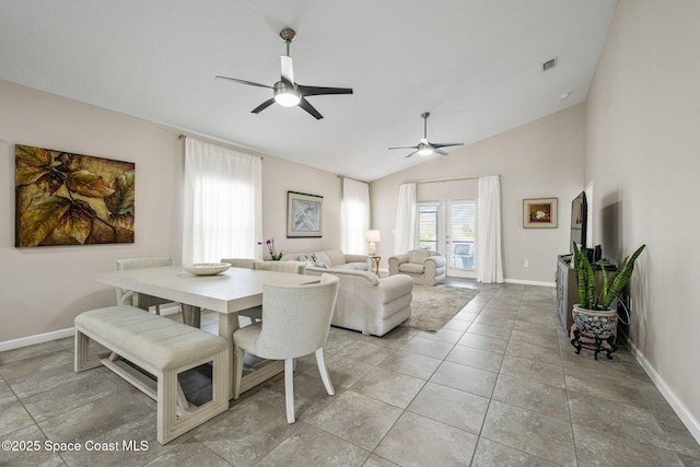 tiled dining room with lofted ceiling and ceiling fan