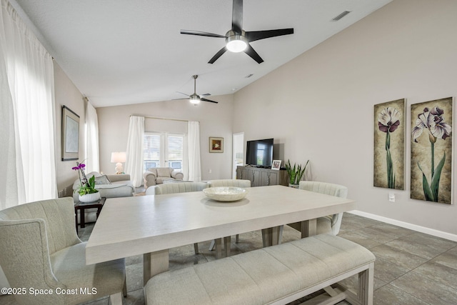 dining area with high vaulted ceiling