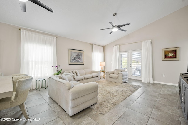 tiled living room featuring ceiling fan and high vaulted ceiling