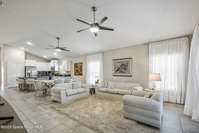 tiled living room featuring lofted ceiling and ceiling fan