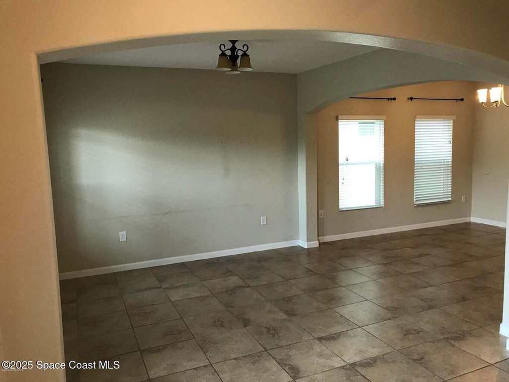 spare room with a chandelier