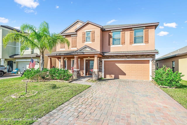 view of front of home with a garage and a front lawn