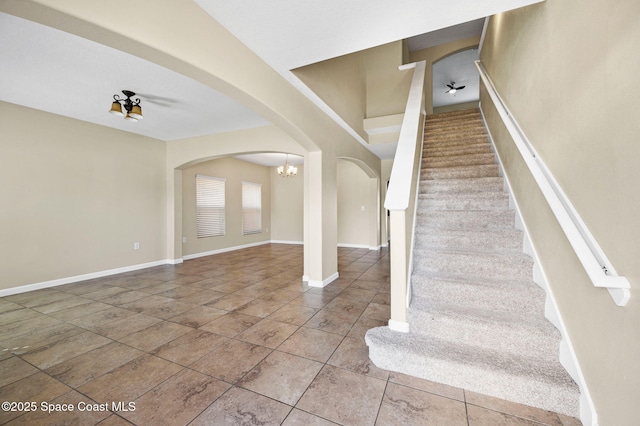 stairway with tile patterned floors