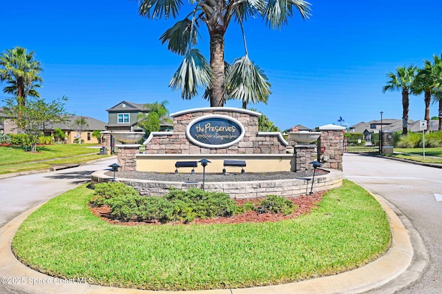 community / neighborhood sign with a lawn