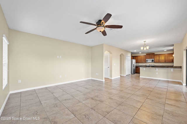 unfurnished living room featuring light tile patterned floors and ceiling fan with notable chandelier