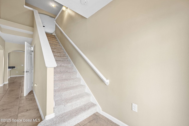 stairs featuring tile patterned floors