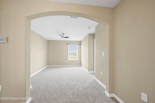 spare room with ceiling fan and carpet flooring