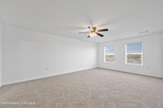 unfurnished room with ceiling fan, a textured ceiling, and carpet