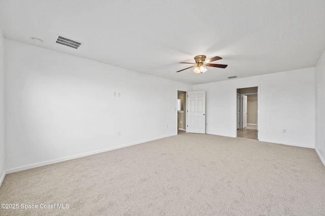 spare room with ceiling fan and light colored carpet