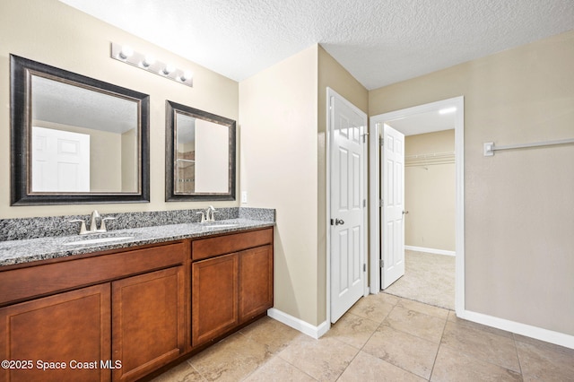 bathroom with vanity and a textured ceiling