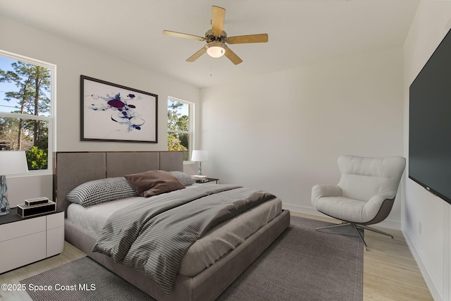 bedroom with ceiling fan and light wood-type flooring