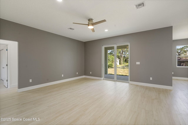 unfurnished room with ceiling fan and light wood-type flooring