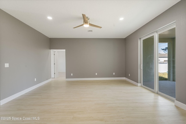 empty room featuring ceiling fan and light hardwood / wood-style floors