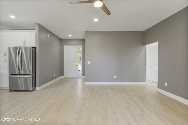 interior space with ceiling fan and light wood-type flooring