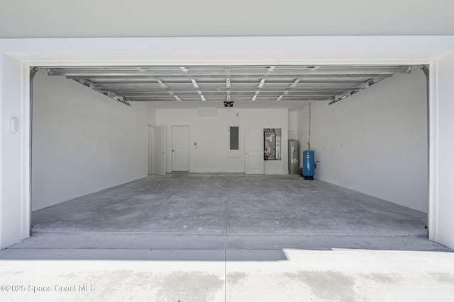 garage featuring water heater and electric panel