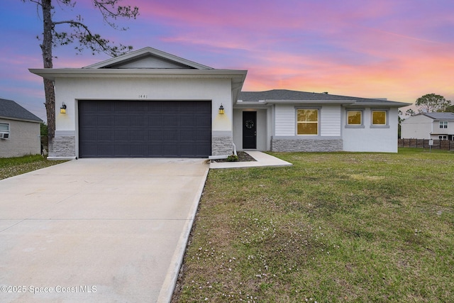 view of front of property with a yard and a garage