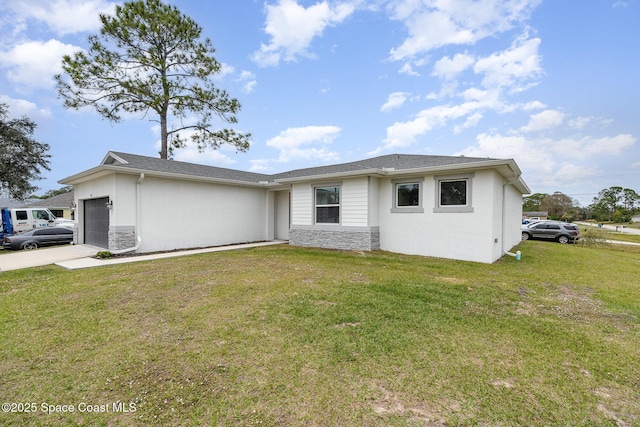 single story home with a garage and a front lawn