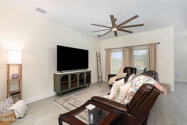 living room featuring light hardwood / wood-style flooring and ceiling fan