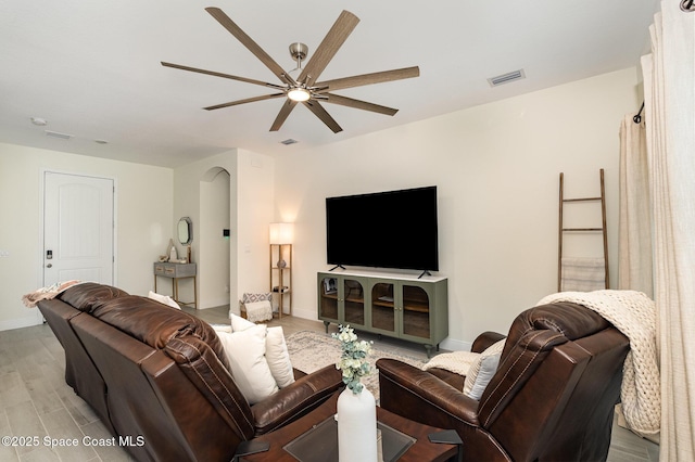 living room with ceiling fan and light wood-type flooring