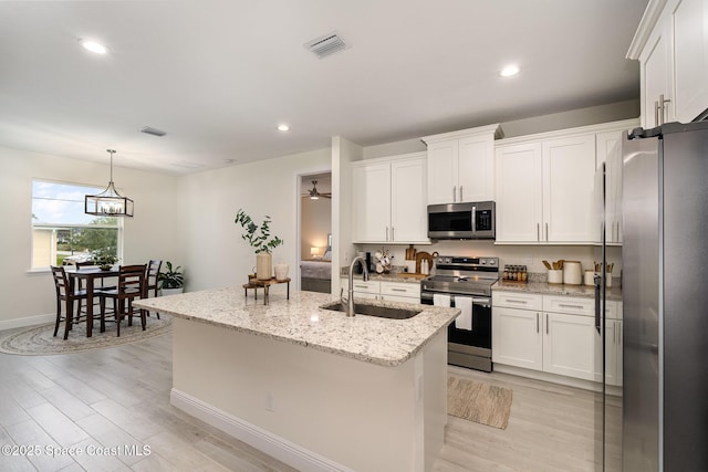 kitchen with white cabinetry, an island with sink, appliances with stainless steel finishes, and sink