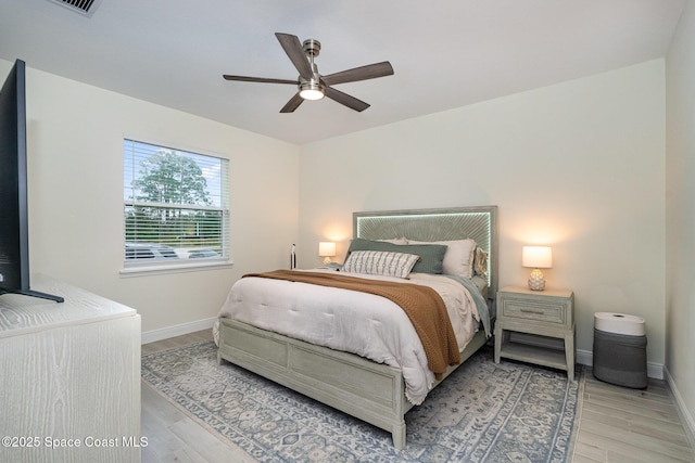 bedroom with wood-type flooring and ceiling fan