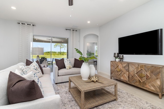 living room featuring ceiling fan and light wood-type flooring