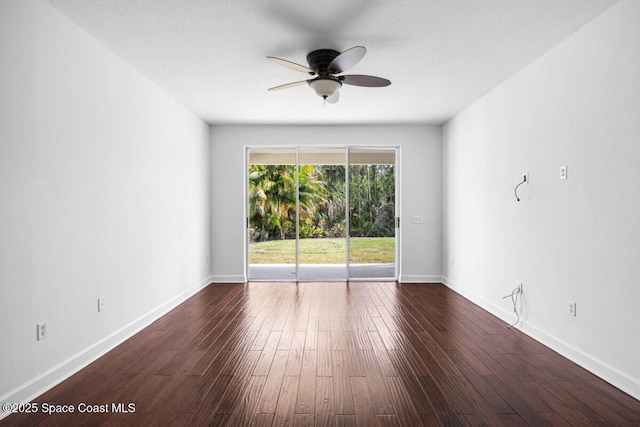 empty room with dark wood-type flooring and ceiling fan