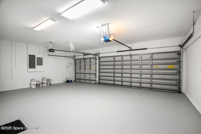 garage with a garage door opener and electric panel