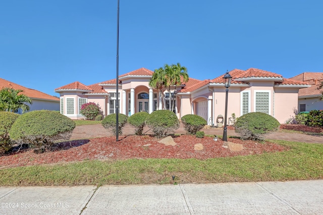 mediterranean / spanish-style house featuring a garage