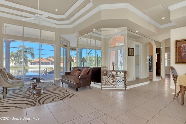 sunroom / solarium with ceiling fan and a water view