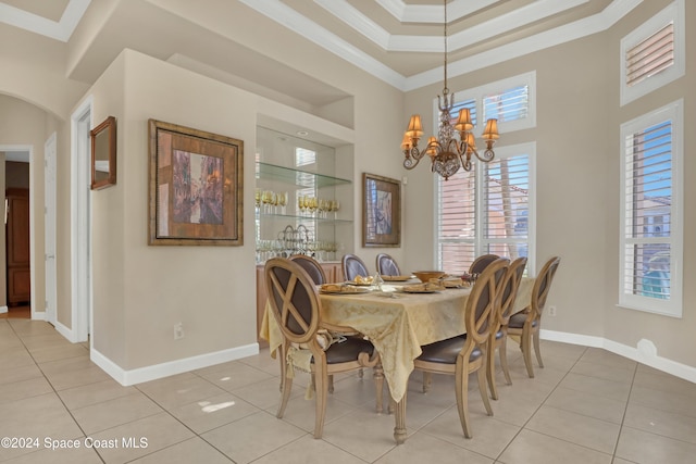 dining space with an inviting chandelier, light tile patterned floors, and crown molding