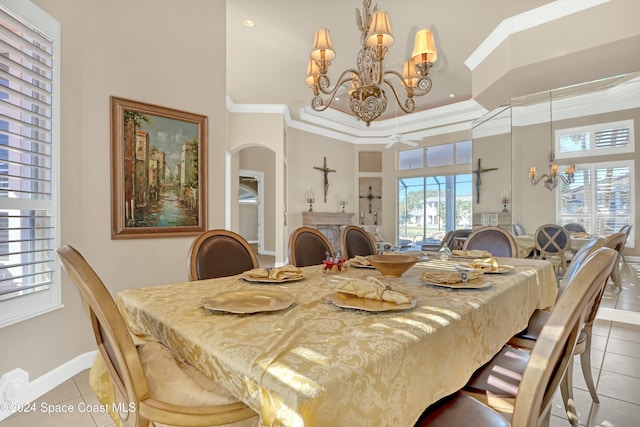 tiled dining area with crown molding, a towering ceiling, and a notable chandelier