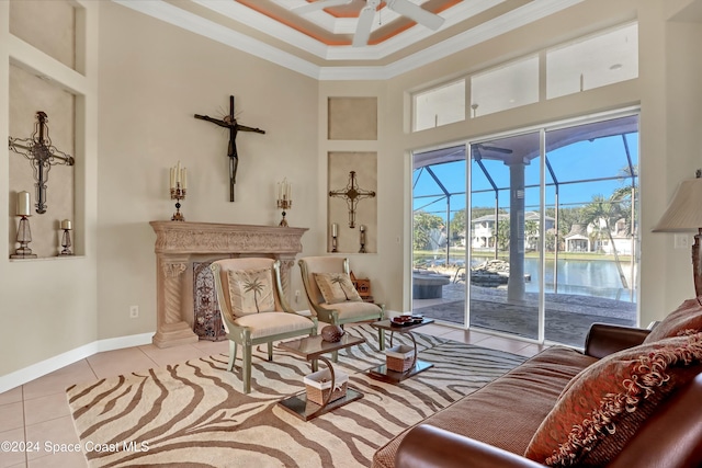 sitting room featuring a high ceiling, ornamental molding, light tile patterned floors, ceiling fan, and a water view