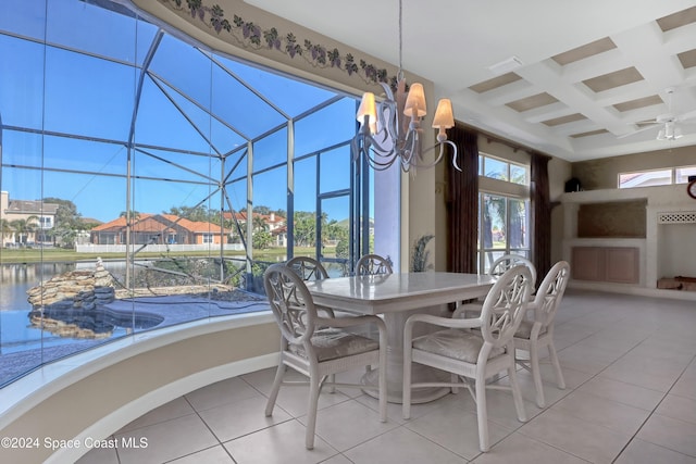 dining area with tile patterned flooring, beam ceiling, a water view, coffered ceiling, and a chandelier