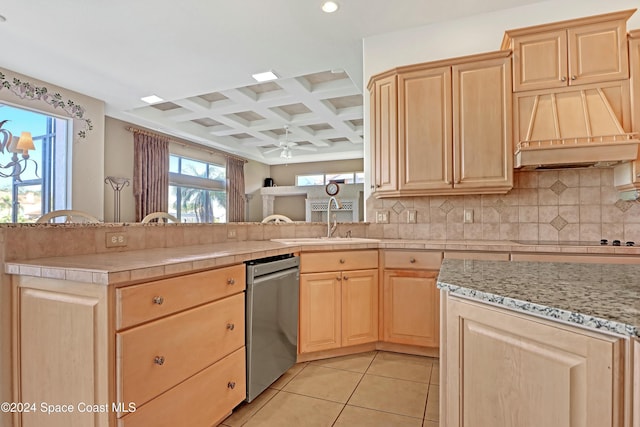 kitchen featuring stainless steel dishwasher and light brown cabinets