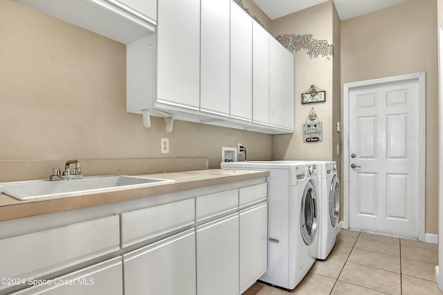 washroom with separate washer and dryer, sink, cabinets, and light tile patterned flooring