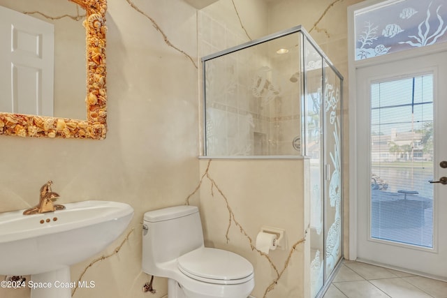 bathroom featuring sink, toilet, an enclosed shower, and tile patterned flooring