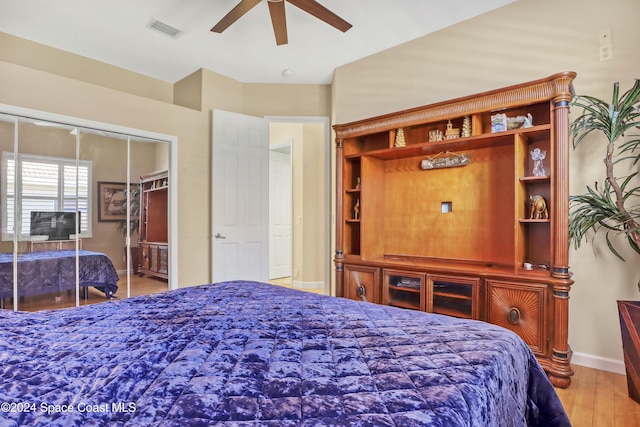 bedroom featuring a closet, ceiling fan, and light wood-type flooring