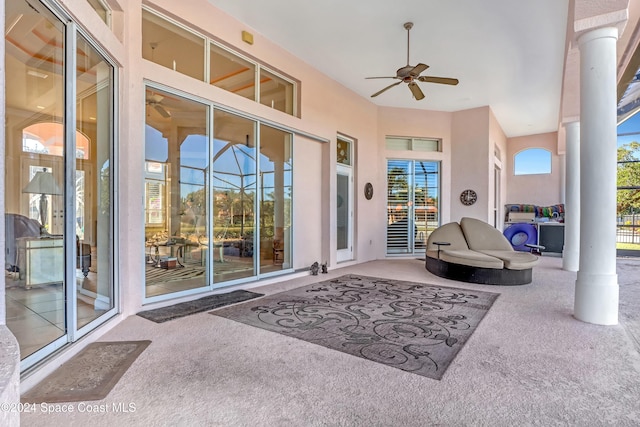 view of patio featuring a lanai and ceiling fan