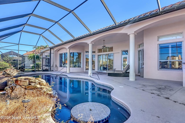 view of swimming pool featuring ceiling fan, a patio, and glass enclosure