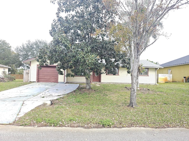 view of front of home with a garage and a front lawn