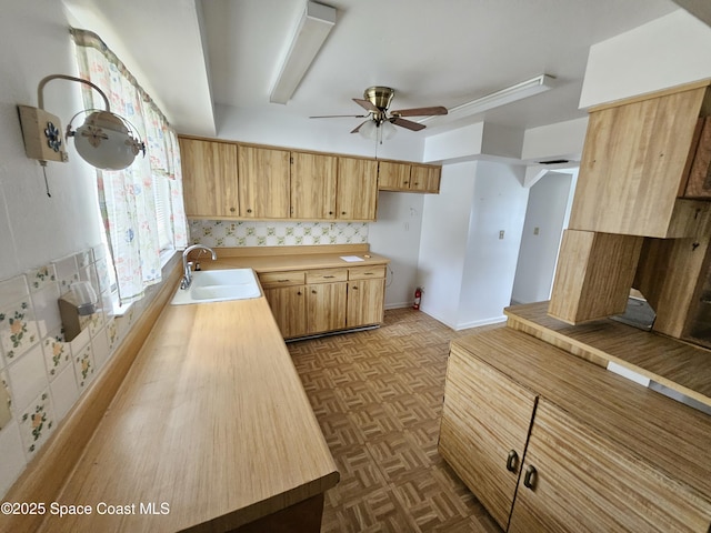 kitchen with light parquet floors, sink, and ceiling fan