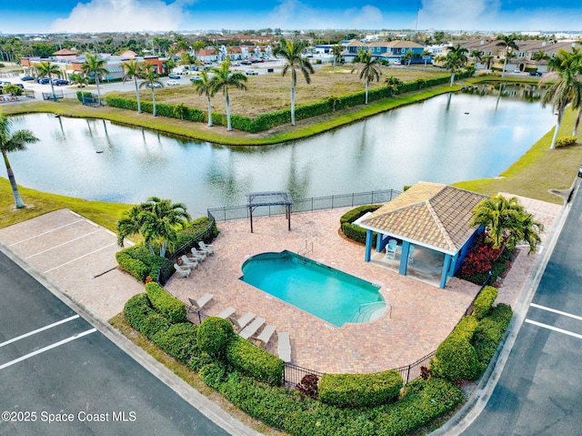 view of swimming pool featuring a gazebo, a water view, and a patio area