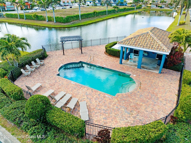 view of swimming pool with a water view and a patio