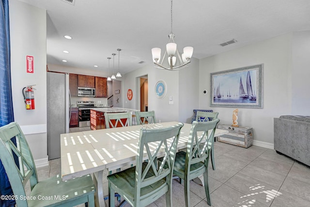 dining space featuring light tile patterned flooring and a chandelier