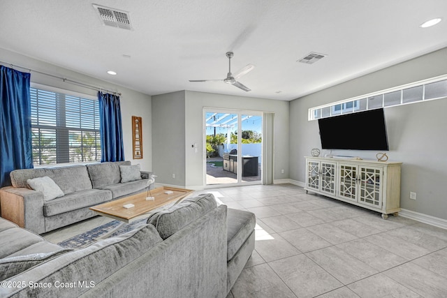 living room featuring ceiling fan and tile patterned flooring