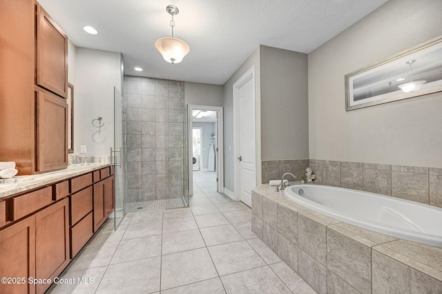 bathroom with tile patterned floors, vanity, and separate shower and tub