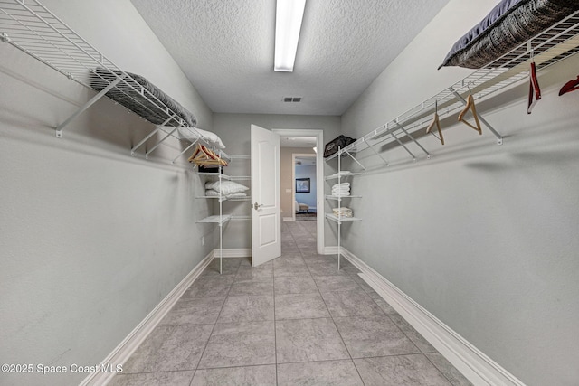 spacious closet featuring tile patterned flooring